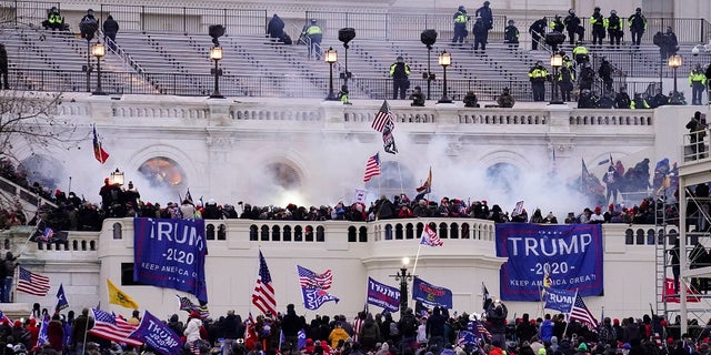 In this file photo from Jan.6, 2021, violent protesters loyal to President Donald Trump storm the Capitol in Washington.  On Friday August 6, 2021, Seattle Police Chief Adrian Diaz fired the two Seattle police officers who broke the law while attending events in Washington DC during the January 6 uprising.  Diaz said he fired Caitlin and Alexander Everett, the two married officers, with immediate effect.  (AP Photo / John Minchillo, file)