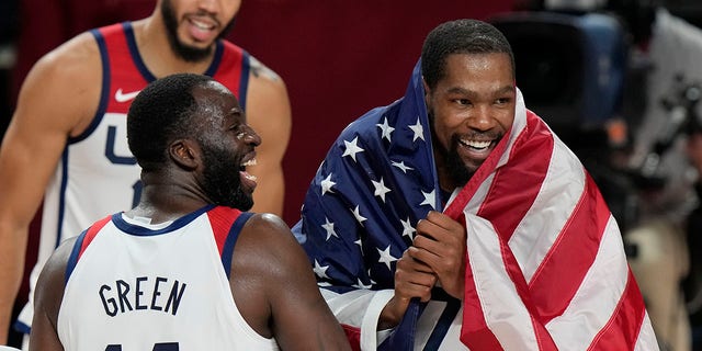 United States' Kevin Durant (7), right, and teammates celebrate after their win in the men's basketball gold medal game against France at the 2020 Summer Olympics, Saturday, Aug. 7, 2021, in Saitama, Japan. (AP Photo/Luca Bruno)