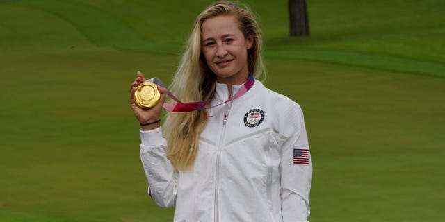 Nelly Korda, of the United States, poses with her gold medal, won in the women's golf event at the 2020 Summer Olympics, Saturday, Aug. 7, 2021, at the Kasumigaseki Country Club in Kawagoe, Japan. (AP Photo/Matt York)