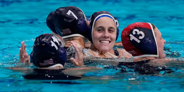 United States' Alys Williams, center, celebrates with teammates after beating Spain in the women's water polo gold medal match at the 2020 Summer Olympics, Saturday, Aug. 7, 2021, in Tokyo, Japan. (AP Photo/Mark Humphrey)