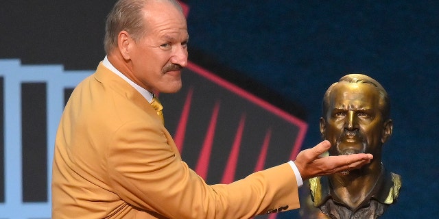Bill Cowher, a member of the Pro Football Hall of Fame Centennial Class, smiles after unveiling a bust of himself during the induction ceremony at the Pro Football Hall of Fame, Saturday, Aug. 7, 2021, in Canton, Ohio. (Associated Press)