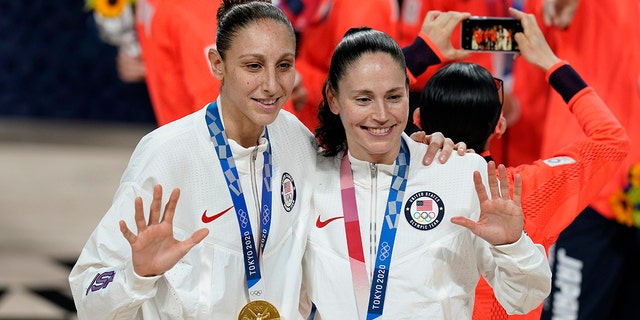 United States's Sue Bird, right, and Diana Taurasi pose with their gold medals during the medal ceremony for women's basketball at the 2020 Summer Olympics, Sunday, Aug. 8, 2021, in Saitama, Japan. (AP Photo/Charlie Neibergall)