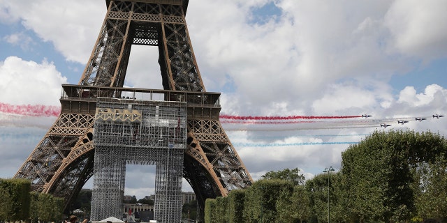 The French Aerial Patrol fly by the Eiffel Tower in Paris.