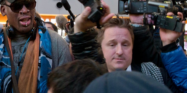 In this Dec. 19, 2013, file photo, Michael Spavor, center, an entrepreneur, is seen with former NBA star Dennis Rodman, left, on the arrival at the capital airport for a flight to North Korea in Beijing, China. The Canadian entrepreneur, who was charged with spying after his government arrested an executive of Chinese tech giant Huawei, faces a possible verdict on Wednesday, Aug. 11, 2021, as Beijing steps up pressure on Canada ahead of a court ruling on whether to hand over the executive to face U.S. criminal charges. (AP Photo/Ng Han Guan, File)