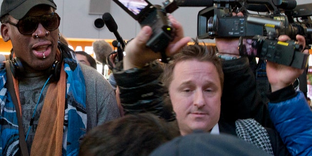 In this Dec. 19, 2013, file photo, Michael Spavor, center, an entrepreneur, is seen with former NBA star Dennis Rodman, left, on the arrival at the capital airport for a flight to North Korea in Beijing, China. The Canadian entrepreneur, who was charged with spying after his government arrested an executive of Chinese tech giant Huawei, faces a possible verdict on Wednesday, Aug. 11, 2021, as Beijing steps up pressure on Canada ahead of a court ruling on whether to hand over the executive to face U.S. criminal charges. (AP Photo/Ng Han Guan, File)