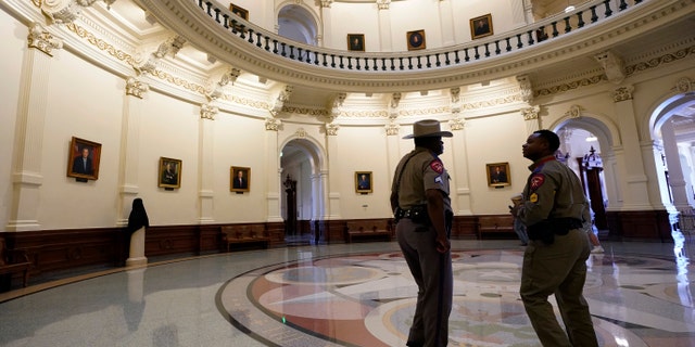 Texas Department of Safety officers stand watch over the Texas Capitol, Wednesday, Aug. 11, 2021, in Austin, Texas. Officers of the Texas House of Representatives delivered civil arrest warrants for more than 50 absent Democrats on Wednesday as frustrated Republicans ratcheted up efforts to end a standoff over a sweeping elections bill that stretched into its 31st day. (AP Photo/Eric Gay)