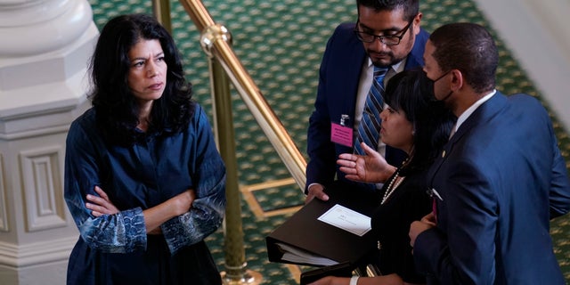 Texas state Sen. Carol Alvarado, D-Houston, talks with staff as she prepares to filibuster Senate Bill 1, a voting bill, at the Texas Capitol, Wednesday, Aug. 11, 2021, in Austin, Texas. (AP Photo/Eric Gay)