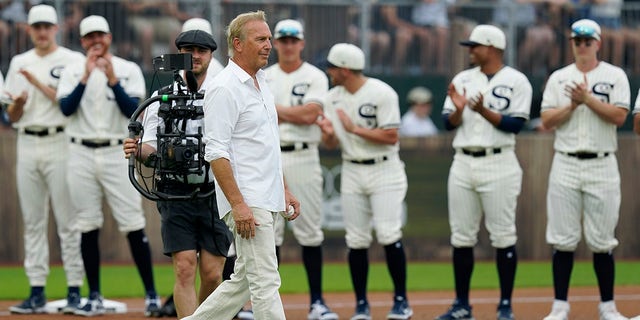 Actor Kevin Costner walks to the stands before a baseball game between the New York Yankees and Chicago White Sox, Thursday, Aug. 12, 2021 in Dyersville, Iowa. (AP Photo/Charlie Neibergall)