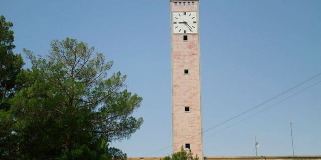 A Taliban flag flies from the clocktower of the Herat provincial official office, in Herat, Afghanistan, west of Kabul, on Saturday, Aug. 14, 2021. (AP Photo/Hamed Sarfarazi)