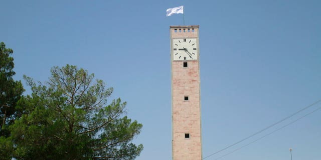 A Taliban flag flies over the clock tower of the Herat Province official office in Herat, Afghanistan, west of Kabul on Saturday August 14, 2021. (AP Photo / Hamed Sarfarazi)