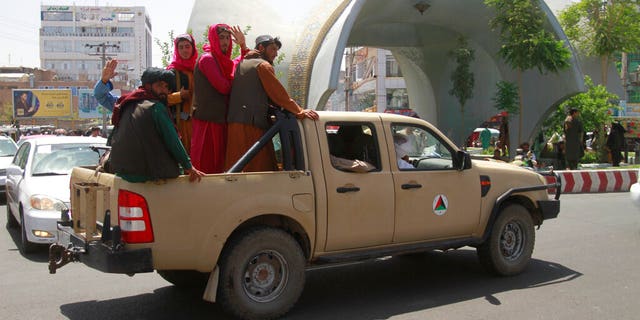 Taliban fighters pose in the back of a vehicle in the town of Herat, west of Kabul, Afghanistan, on Saturday August 14, 2021, after taking that province from the Afghan government. The Taliban seized two other provinces and approached the outskirts of the Afghan capital. (AP Photo / Hamed Sarfarazi)