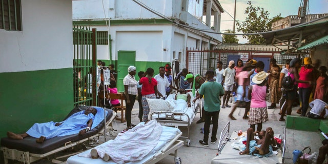 People injured during the earthquake are treated in the hospital in Les Cayes, Haiti, Sunday, Aug. 15, 2021. The death toll from a magnitude 7.2 earthquake in Haiti climbed to more than 1,200 on Sunday as rescuers raced to find survivors amid the rubble ahead an approaching tropical storm.  (AP Photo/Joseph Odelyn)