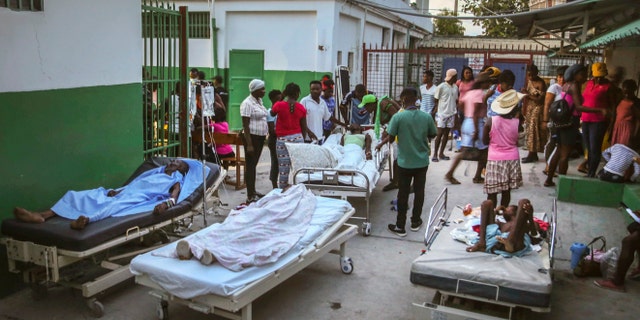 People injured during the earthquake are treated in the hospital in Les Cayes, Haiti, Sunday, Aug. 15, 2021. The death toll from a magnitude 7.2 earthquake in Haiti climbed to more than 1,200 on Sunday as rescuers raced to find survivors amid the rubble ahead an approaching tropical storm. (AP Photo/Joseph Odelyn)