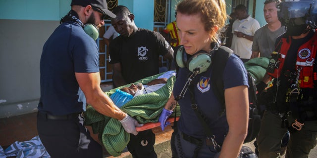 A person injured in the earthquake is transferred to a US Coast Guard helicopter in Les Cayes, Haiti, Monday, Aug. 16, 2021, two days after a 7.2-magnitude earthquake struck the southwestern part of the country. (AP Photo/Joseph Odelyn)
