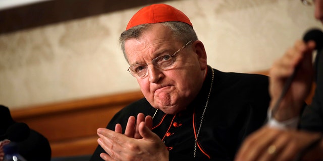 Cardinal Raymond Burke applauds during a press conference at the Italian Senate, in Rome, in 2018.