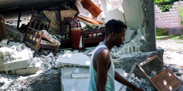 A collapsed home lays in ruins in Saint-Louis-du-Sud, Haiti, Monday, Aug. 16, 2021, two days after a 7.2-magnitude earthquake struck the southwestern part of the country. (AP Photo/Matias Delacroix)