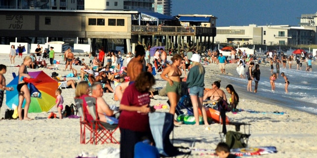 Beachgoers are shown on the coast at Gulf Shores, Alabama, on Thursday, Aug. 12, 2021. (Associated Press)