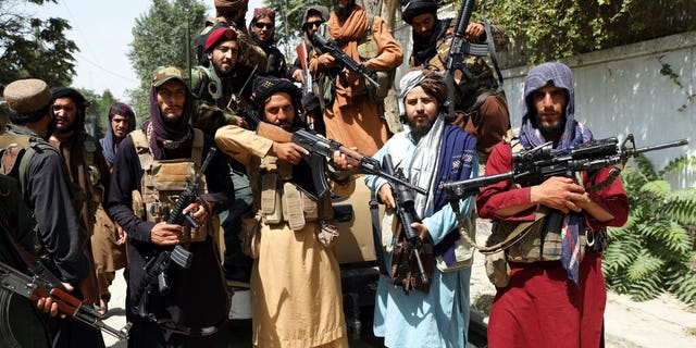 Taliban fighters pose for a photograph in Kabul, Afghanistan, Thursday, Aug. 19, 2021. The Taliban celebrated Afghanistan's Independence Day on Thursday by declaring they beat the United States, but challenges to their rule ranging from running a country severely short on cash and bureaucrats to potentially facing an armed opposition began to emerge. (AP Photo/Rahmat Gul)