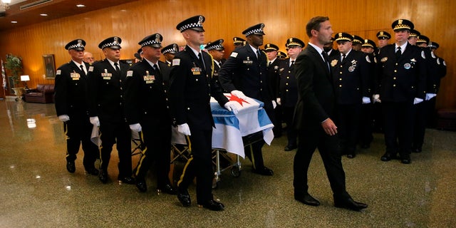 The casket of Chicago police Officer Ella French is brought through the vestibule before the funeral service for French on Thursday, Aug. 19, 2021, at St. Rita of Cascia Shrine Chapel  in Chicago.  French was killed and her partner was seriously wounded during an Aug. 7 traffic stop on the city's South Side. 