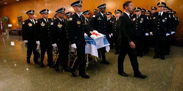 The casket of Chicago police Officer Ella French is brought through the vestibule before the funeral service for French on Thursday, Aug. 19, 2021, at St. Rita of Cascia Shrine Chapel  in Chicago.  French was killed and her partner was seriously wounded during an Aug. 7 traffic stop on the city's South Side. 