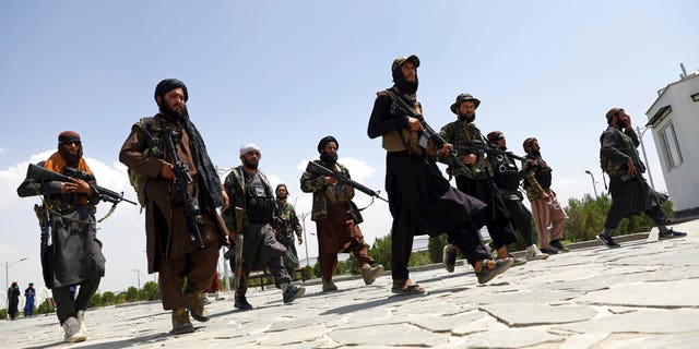 In this Aug. 19, 2021, file photo, Taliban fighters patrol in Kabul, Afghanistan. After the Taliban takeover, employees of the collapsed government, civil society activists and women are among the at-risk Afghans who have gone into hiding or are staying off the streets. (AP Photo/Rahmat Gul, File)