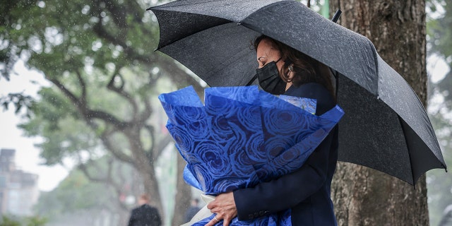 U.S. Vice President Kamala Harris lays flowers at the Senator John McCain memorial site, where his Navy aircraft was shot down by the North Vietnamese, on the three-year anniversary of his death, in Hanoi, Vietnam, Wednesday, Aug. 25, 2021. (Evelyn Hockstein/Pool Photo via AP)