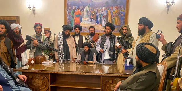 FILE - In this Aug. 15, 2021 file photo, Taliban fighters take control of Afghan presidential palace in Kabul, Afghanistan, after President Ashraf Ghani fled the country. (AP Photo/Zabi Karimi, File)