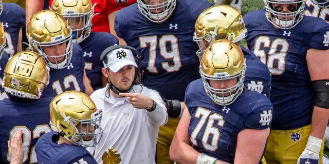 FILE - In this May 1, 2021, file photo, Notre Dame offensive coordinator Tommy Rees talks with players during a timeout in the Blue-Gold NCAA spring football game in South Bend, Ind. The 2021 challenge for Rees is to improve considerably from last season’s scoring output of 33.4 points per game. (AP Photo/Robert Franklin, File)