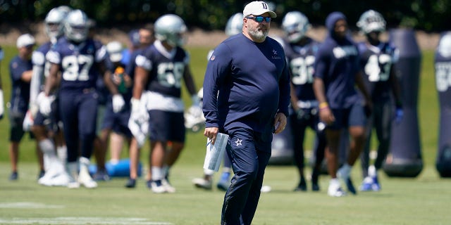 Dallas Cowboys head coach Mike McCarthy walks across the field as he watches workouts at the team's NFL football training facility in Frisco, Texas, Wednesday, Aug. 25, 2021. (AP Photo/Tony Gutierrez)