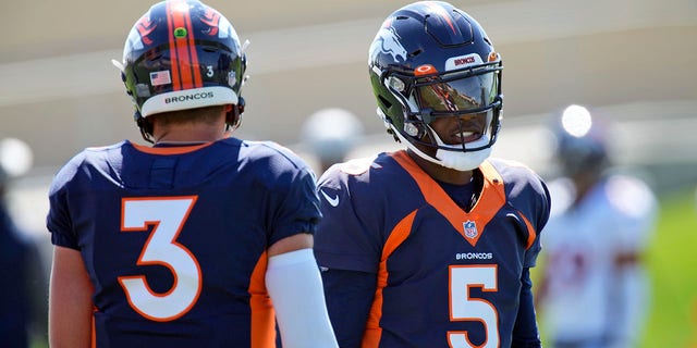 Denver Broncos quarterbacks Teddy Bridgewater, right, and Drew Lock participate in drills during an NFL football practice at team headquarters on Wednesday, August 25, 2021, in Englewood, Colorado. 