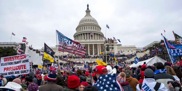 FILE - In this Jan. 6, 2021, file photo insurrections loyal to President Donald Trump rally at the U.S. Capitol in Washington. U.S. Capitol Police officers who were attacked and beaten during the Capitol riot filed a lawsuit Thursday, Aug. 26, against former President Donald Trump, his allies and members of far-right extremist groups, accusing them of intentionally sending insurrectionists to disrupt the congressional certification of the election in January. 