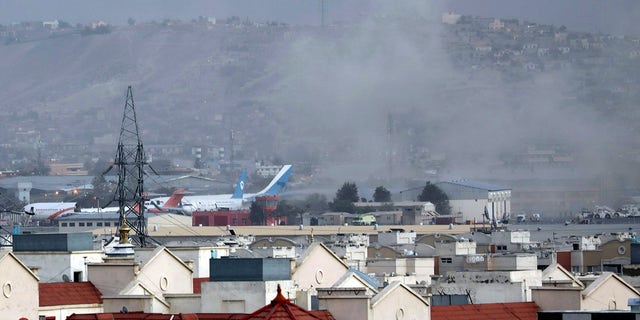 Smoke rises from a deadly explosion outside the airport in Kabul, Afghanistan, Thursday, Aug. 26, 2021.  (AP Photo/Wali Sabawoon)