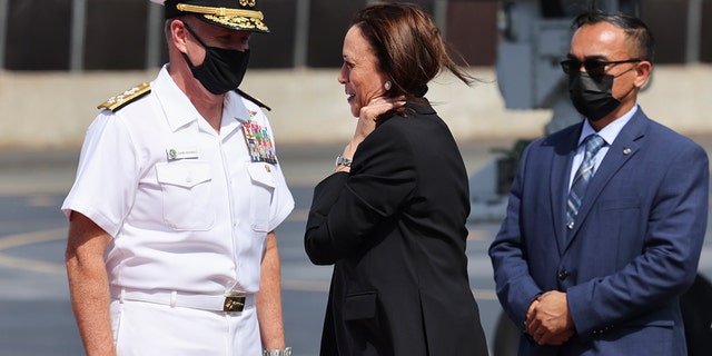 U.S. Vice President Kamala Harris is received by Adm. Samuel Paparo, left, Commander of the U.S. Pacific Fleet, as she arrives at Joint Base Pearl Harbor-Hickam, Hawaii, before continuing to Washington, Thursday, Aug. 26, 2021. (Evelyn Hockstein/Pool Photo via WHD)