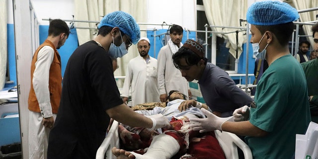 A victim receives medical assistance in a hospital after he was wounded in the deadly attacks outside the airport in Kabul, Afghanistan, Thursday, Aug. 26, 2021. (Associated Press)