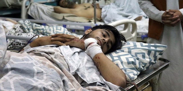 Afghans lie on beds at a hospital after they were wounded in the deadly attacks outside the airport in Kabul, Afghanistan, Thursday, Aug. 26, 2021. (Associated Press)