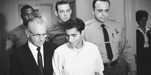 In this June 28, 1968, file photo, Sirhan Bishara Sirhan is escorted by his attorney, Russell E. Parsons from Los Angeles County jail chapel to enter plea to charge of murder in Los Angeles. 