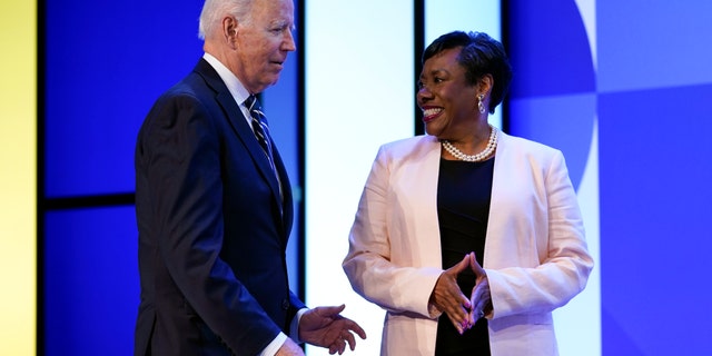 President Joe Biden speaks with National Education Association President Becky Pringle at the NEA's annual meeting at the Walter E. Washington Convention Center in Washington, Friday, July 2, 2021. (AP Photo/Patrick Semansky)