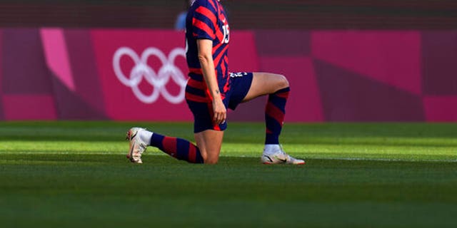 American Megan Rapinoe kneels before the bronze medal soccer match against Australia at the 2020 Summer Olympics on Thursday, August 5, 2021, in Kashima, Japan.  (AP Photo / Fernando Vergara)