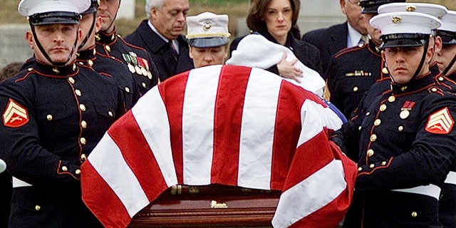 Shannon Spann, wife of CIA officer Johnny Michael "Mike" Spann, follows her husband's casket while holding her 6-month old son Jake, at Arlington National Cemetery in Virginia, on Dec. 10, 2001.