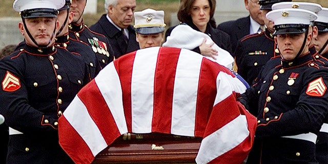 Shannon Spann, wife of CIA officer Johnny Michael "Mike" Spann, follows her husband's casket while holding her 6-month old son Jake, at Arlington National Cemetery in Virginia, on Dec. 10, 2001. 