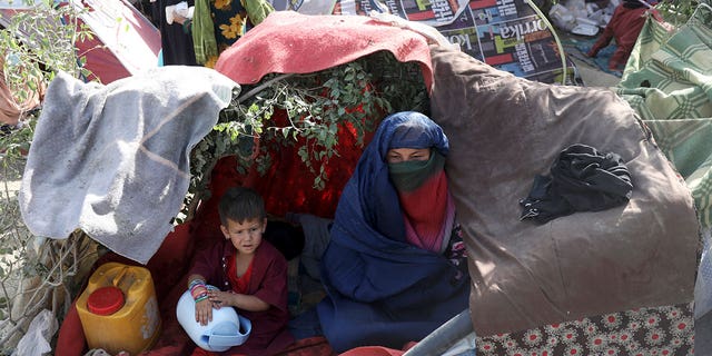 Internally displaced Afghans from northern provinces, who fled their home due to fighting between the Taliban and Afghan security personnel, take refuge in a public park Kabul, Afghanistan, Friday, Aug. 13, 2021. (AP Photo/Rahmat Gul)