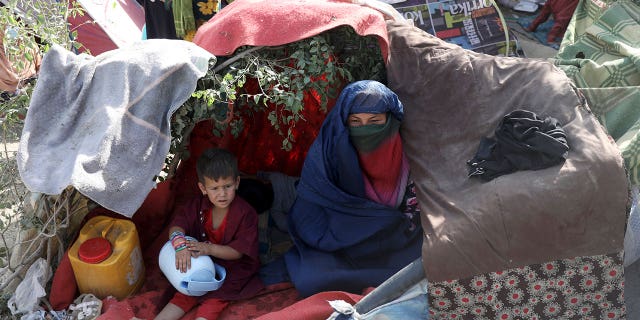 Internally displaced Afghans from northern provinces, who fled their home due to fighting between the Taliban and Afghan security personnel, take refuge in a public park Kabul, Afghanistan, Friday, Aug. 13, 2021. (AP Photo/Rahmat Gul)