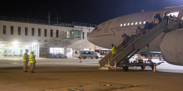 The first flight carrying evacuated personnel of British Embassy staff and various British nationals arrives from Kabul at RAF Brize Norton in England on Aug. 16. (AP/Ministry of Defence)