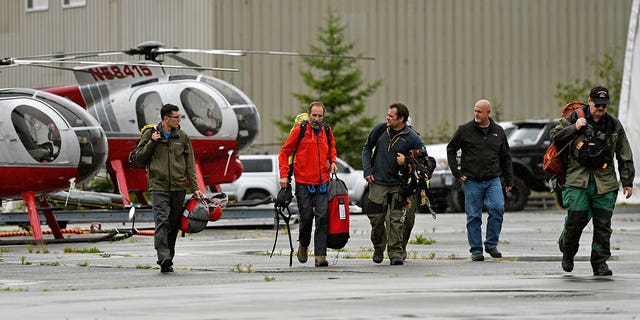 Ketchikan Volunteer Rescue Squad personnel land and board a Hughes 369D helicopter on Thursday, August 5, 2021 at Temsco Helicopters in Ketchikan, Alaska.  (Associated Press)