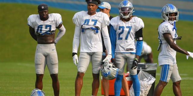 Detroit Lions Jalen Elliott, safety (42), Alex Brown, cornerback (27), and safety Booby Price (47) wait their turn to run drills during Detroit Lions training camp on Aug. 10, 2021, at Lions Practice Facility in Allen Park, Michigan.