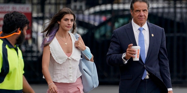 New York Gov. Andrew Cuomo, right, prepares to board a helicopter with his daughter Michaela Cuomo after announcing his resignation, Tuesday, Aug. 10, 2021, in New York. (AP Photo/Seth Wenig)