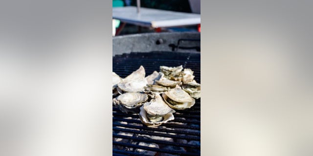 The recipe requires grilling the oysters, either shucking the oysters before grilling, or allowing the heat of the grill to open the oysters. 