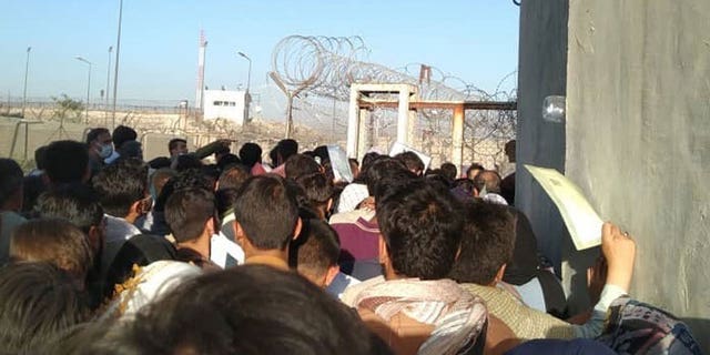 Desperate Afghans crowd into an area near a gate at the Kabul airport, Aug. 26, 2021. (We the People)