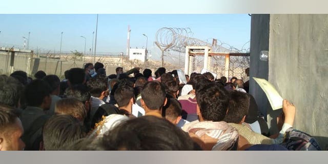 Desperate Afghans crowd into an area near a gate at the Kabul airport, Aug. 26, 2021. (We the People)