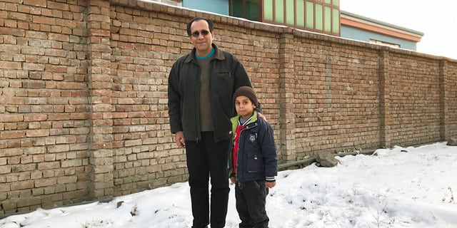 This photo provided by Bahaudin Mujtaba shows Noman Mujtaba, left, and Bahaudin Mujtaba in Kabul, Afghanistan, on Dec. 21, 2017. The boy, now 10 years old, is a distant relative of Mujtaba. (Courtesy of Bahaudin Mujtaba via AP)